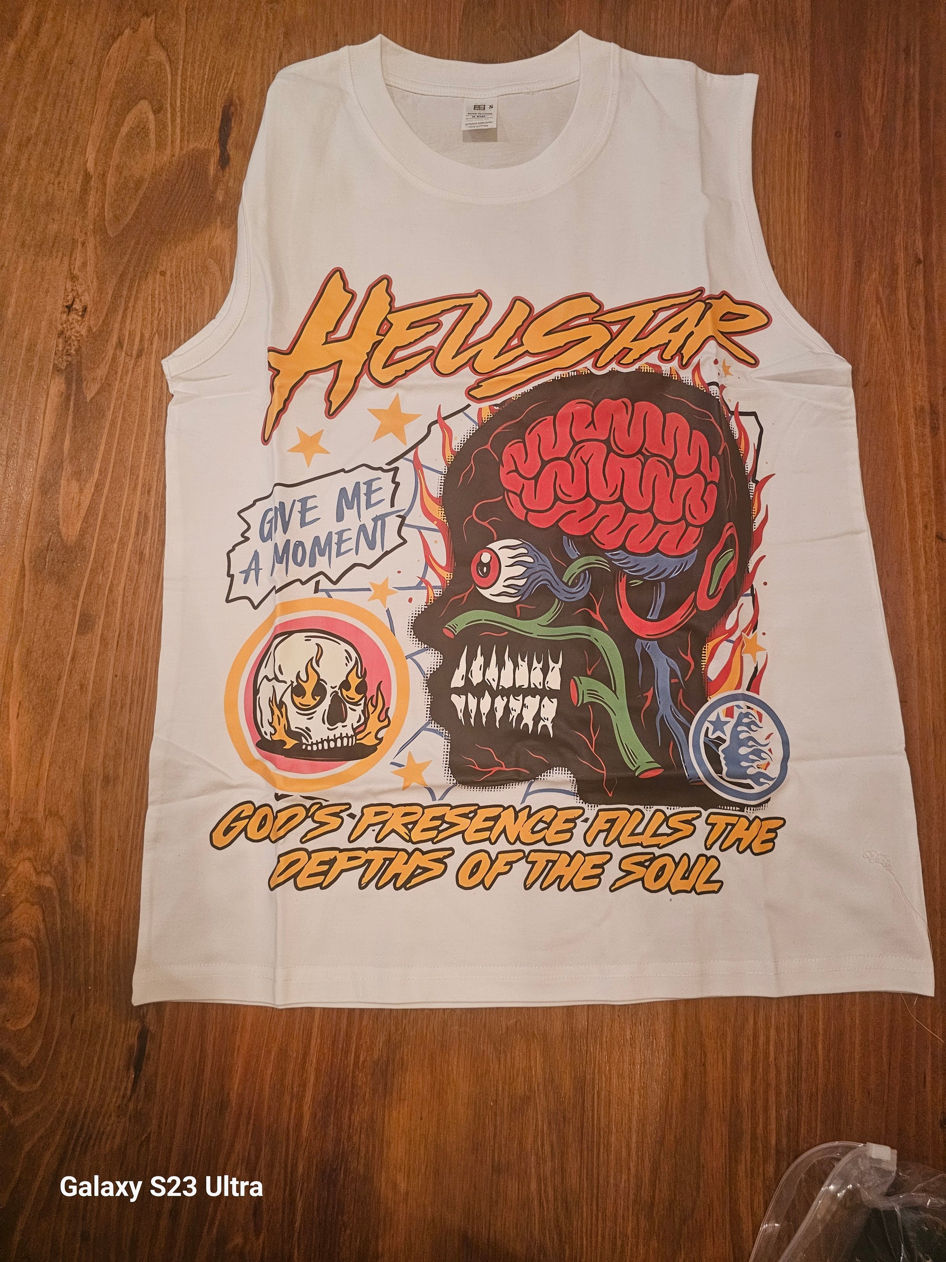 Graphic brain muscle tee featuring colorful skull and brain design on a sleeveless shirt.