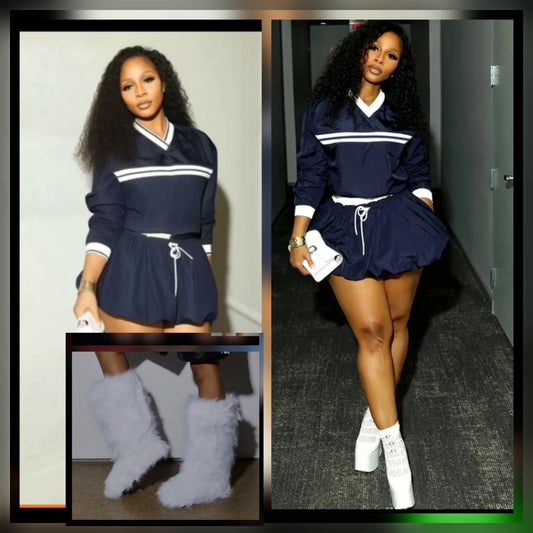 Model showcasing navy skort windbreaker set paired with stylish knee-high fur boots.