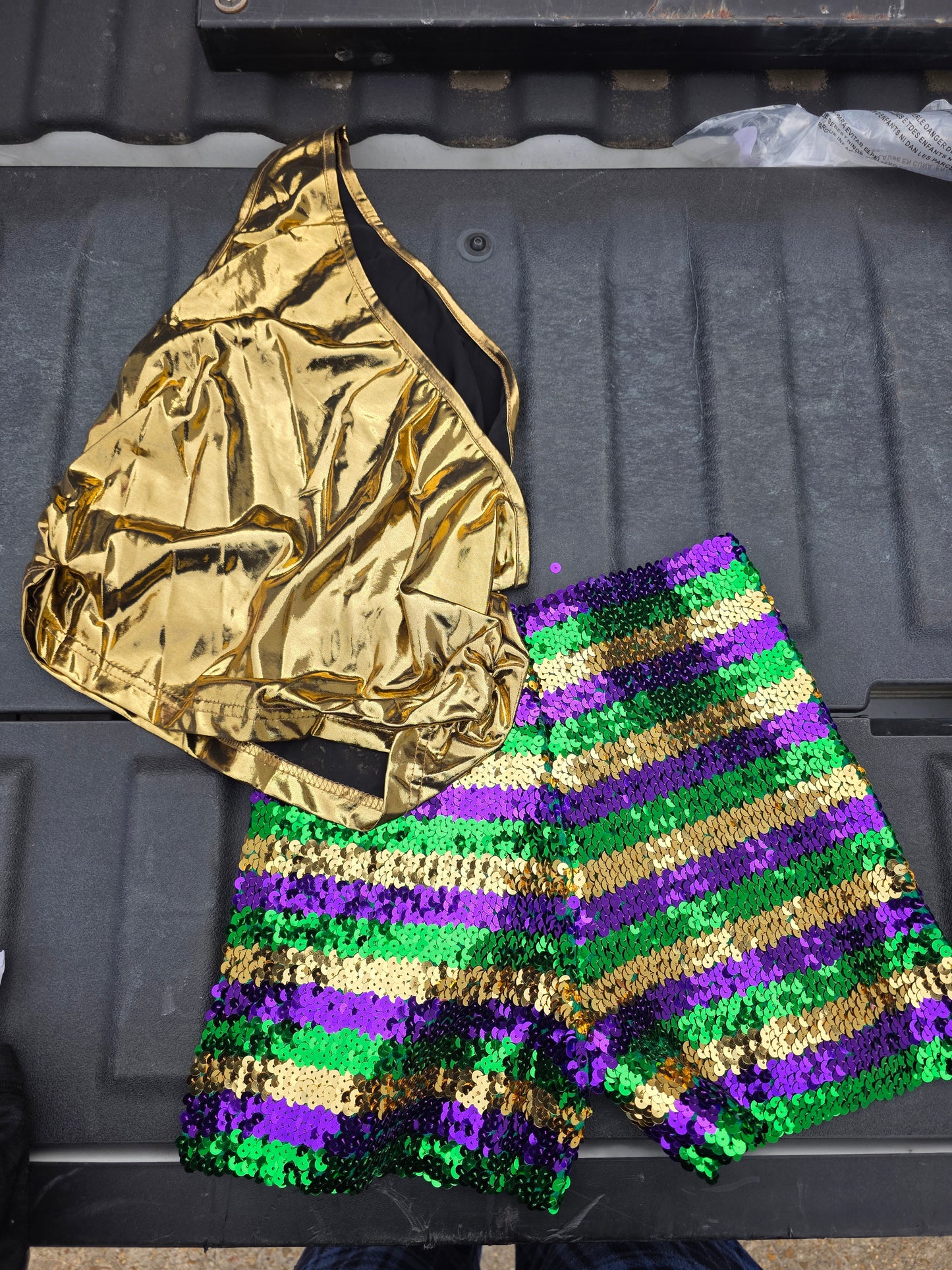 Mardi Gras festive shorts with gold tank top, perfect for celebrating in vibrant style.