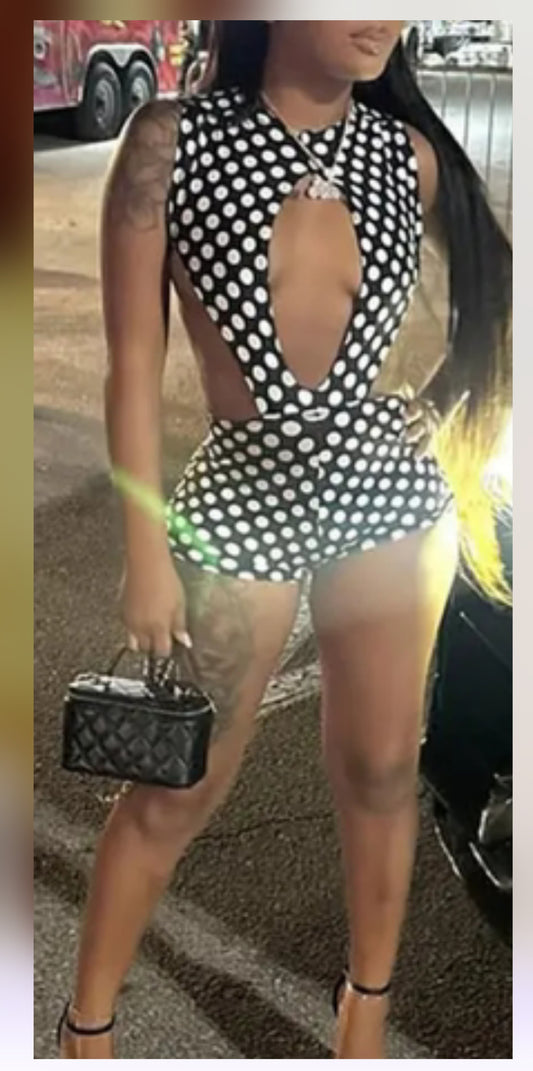 A stylish model showcasing a trendy polka dot romper with a plunging neckline, ideal for summer outings.