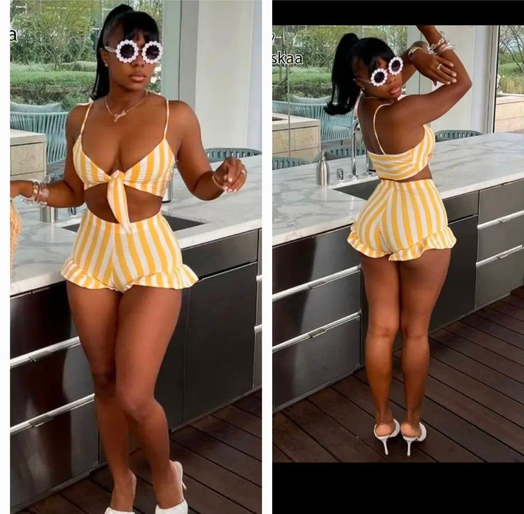 Yellow pinstripe ruffle short set featuring a stylish crop top and matching shorts with ruffles.