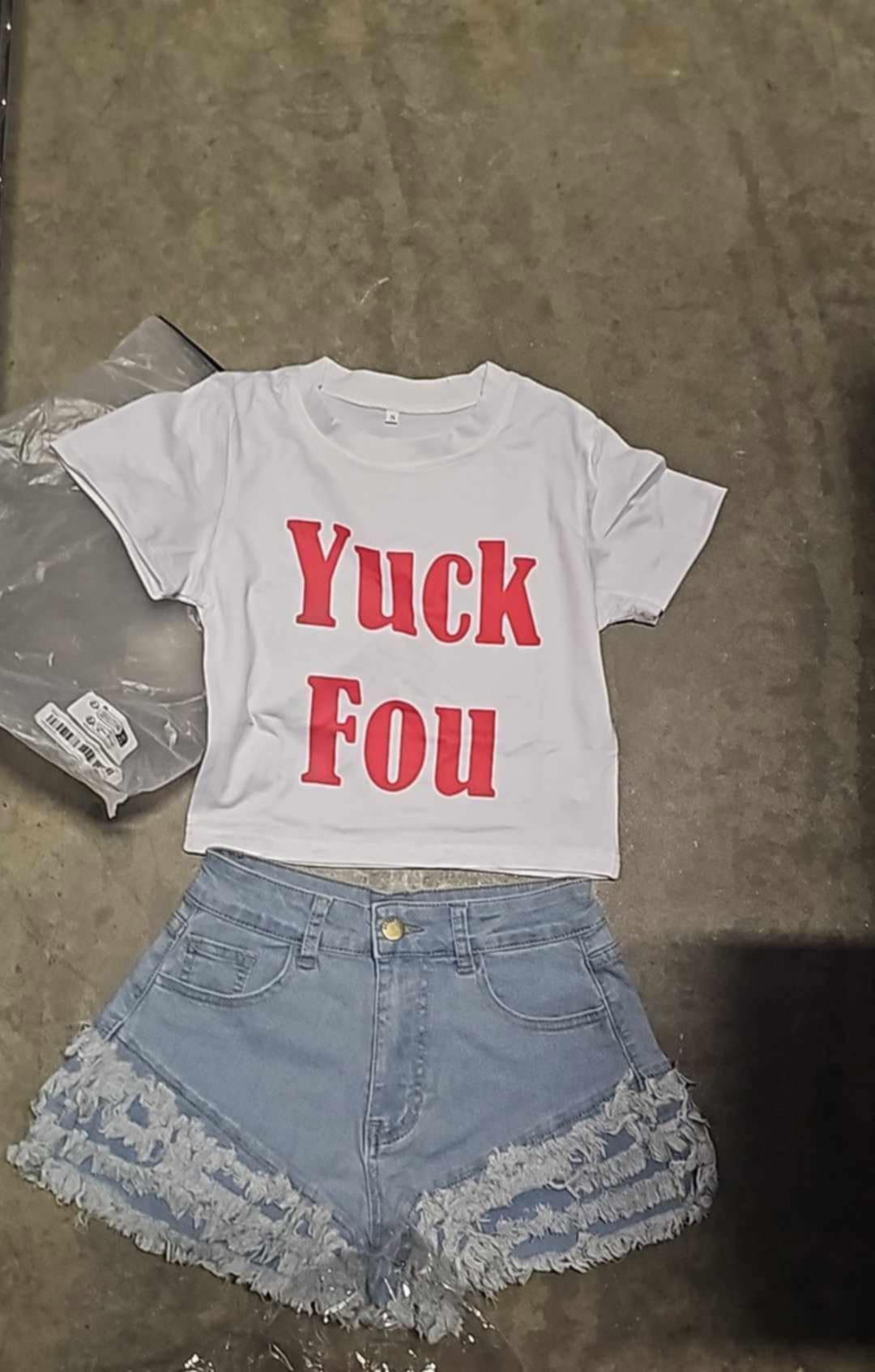 Graphic tee set featuring a white crop top with 'Yuck Fou' in red text paired with denim shorts.
